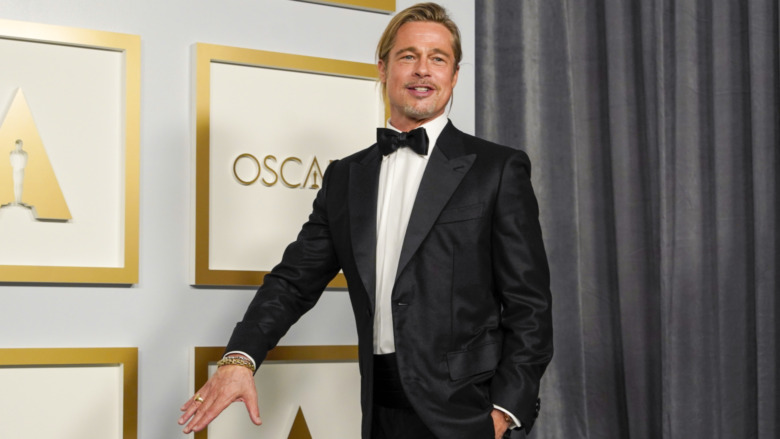 Brad Pitt poses in the press room at the Oscars