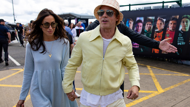 Ines de Ramon and Brad Pitt walking