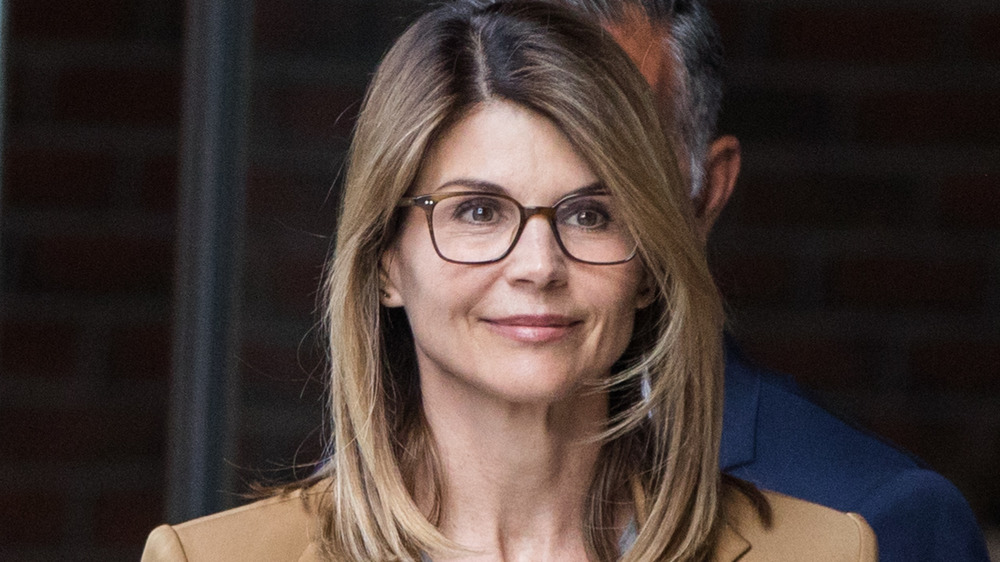 Lori Loughlin smilingoutside of a courtroom in 2019