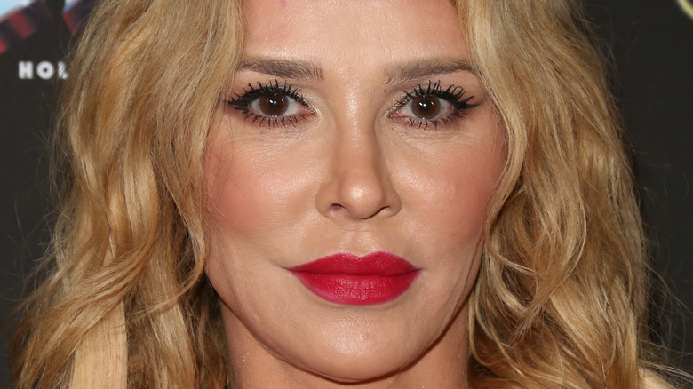 Brandi Glanville wears red lipstick