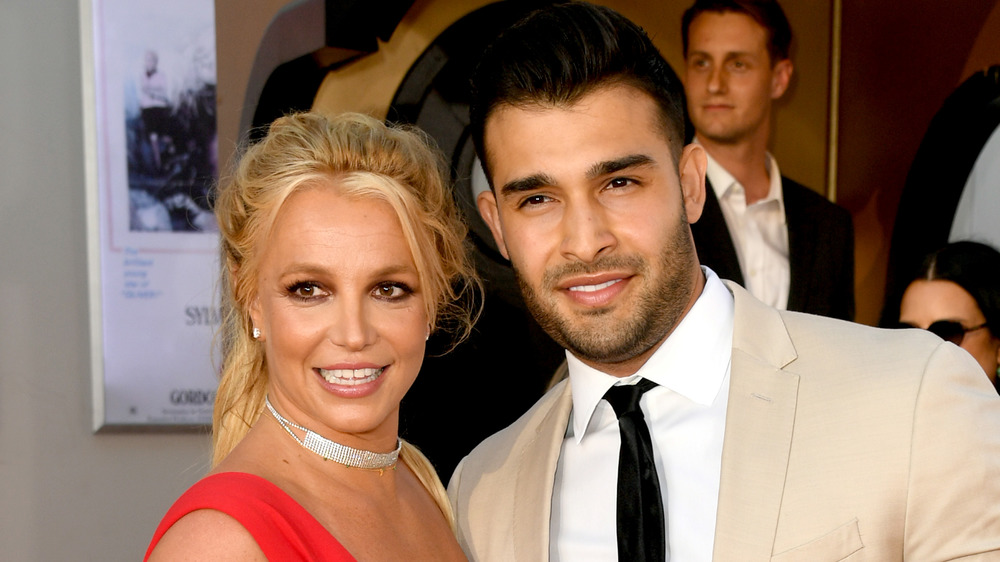 Britney Spears and Sam Asghari posing together at an event