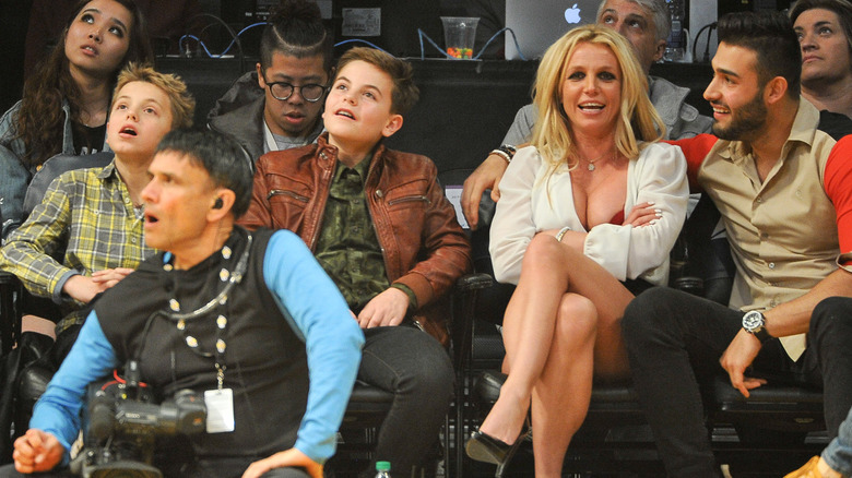 Britney Spears with her husband and two children attending a basketball game