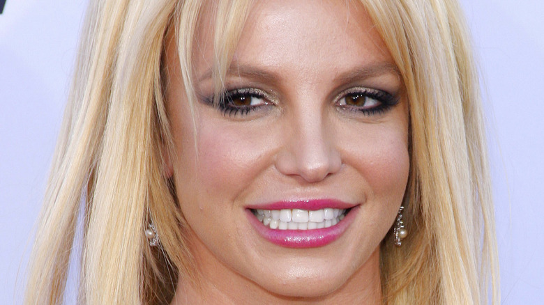 Britney Spears blond bangs pink lipstick