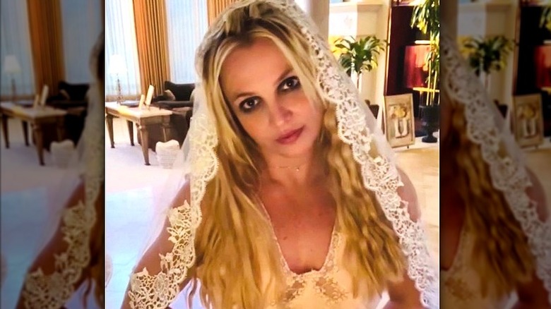 Britney Spears looks at camera in wedding dress