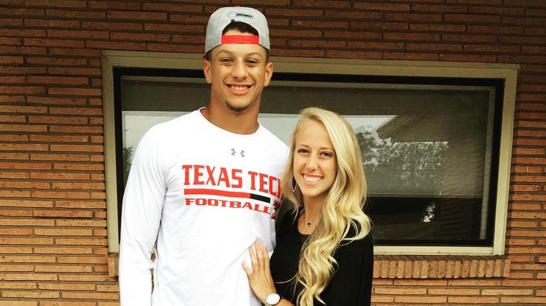 Brittany Mahomes placing hand on Patrick Mahomes' stomach