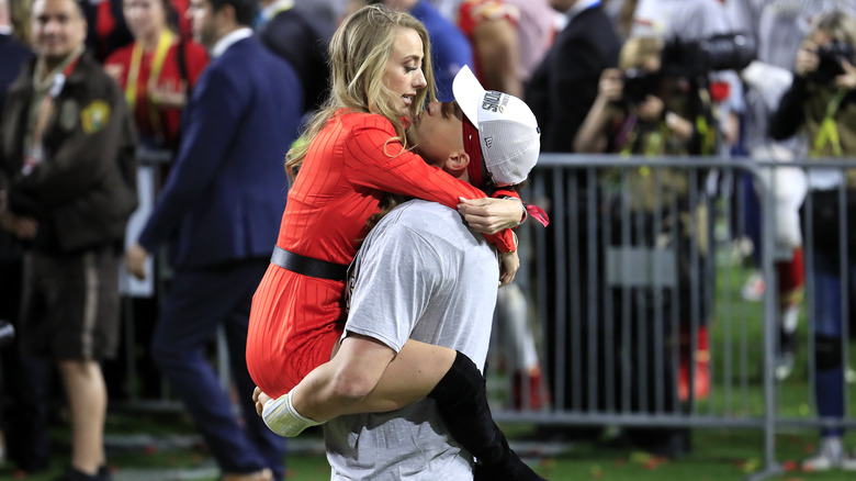 Patrick Mahomes holding Brittany Mahomes