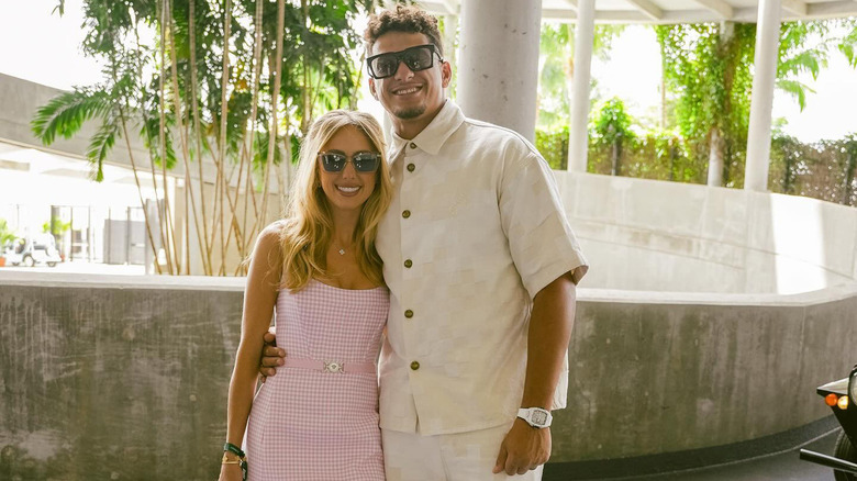 Brittany and Patrick Mahomes smiling in shades