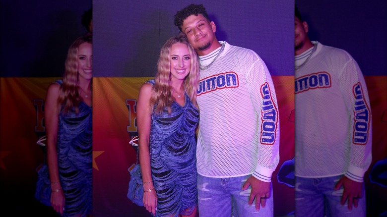 Patrick Mahomes leaning against Brittany Mahomes