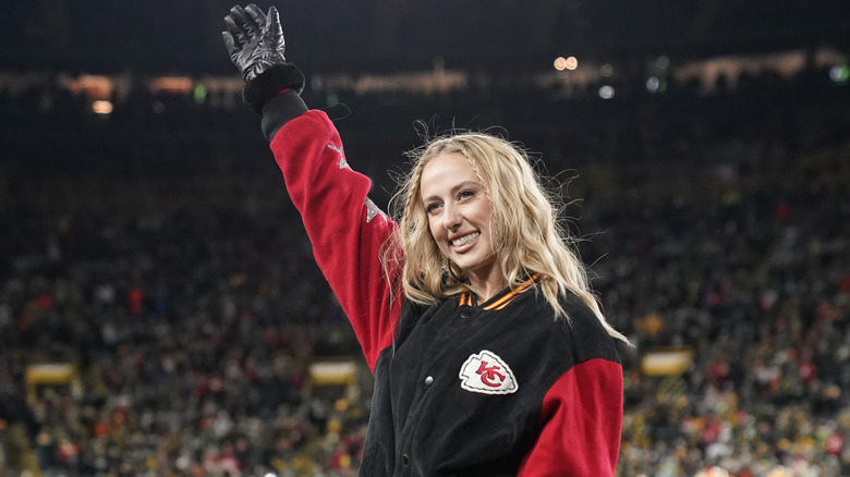 Brittany Mahomes waving on football field