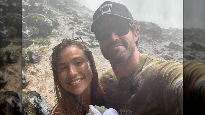 Tia Blanco and Brody Jenner posing near a waterfall