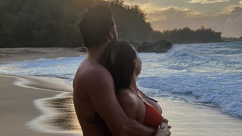 Brody Jenner and Tia Blanco embracing and watching a sunset