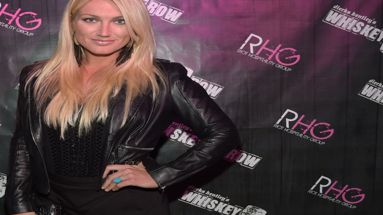 Brooke Hogan posing in black leather outfit