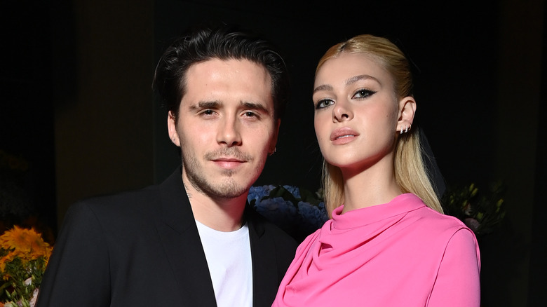 Brooklyn Beckham and Nicola Peltz pose 