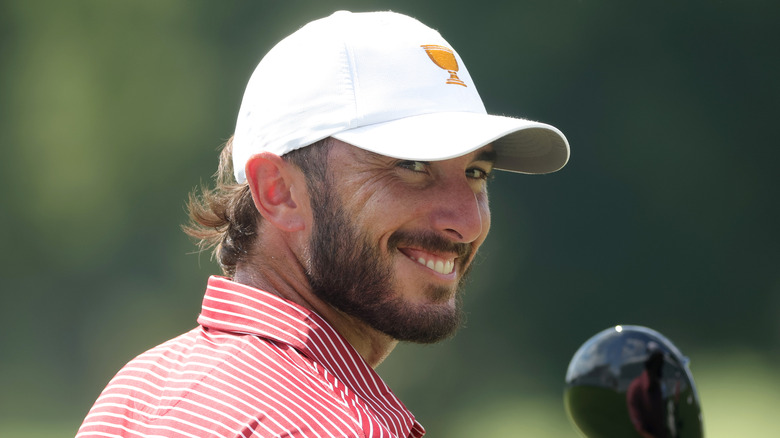 Max Homa smiling and holding a golf club