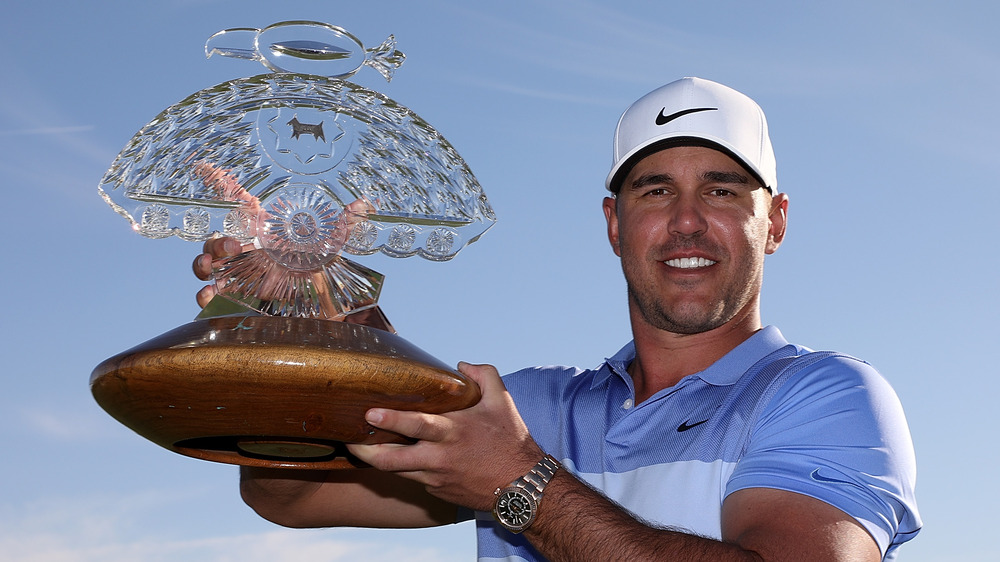 Brooks Koepka holding a trophy