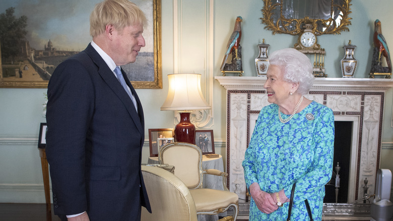 Boris Johnson and Queen Elizabeth smiling 