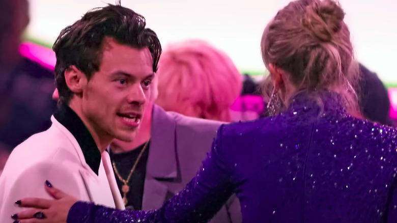 Harry Styles talking to Taylor Swift