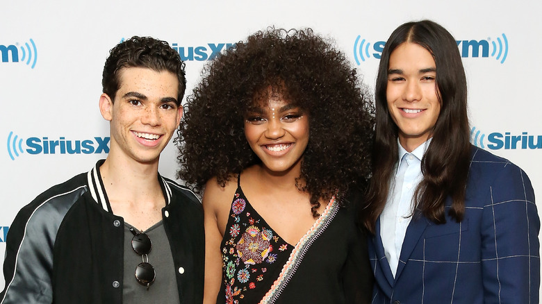 Cameron Boyce, China Anne McClain, and Booboo Stewart posing on a red carpet