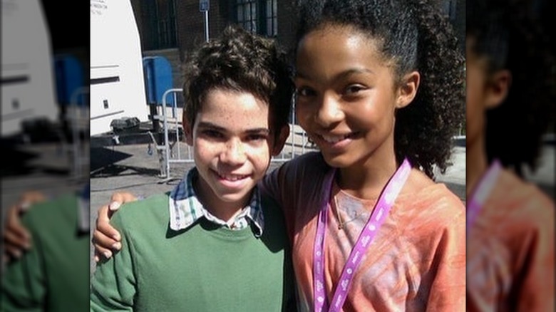 Yara Shahidi and Cameron Boyce smiling together as kids