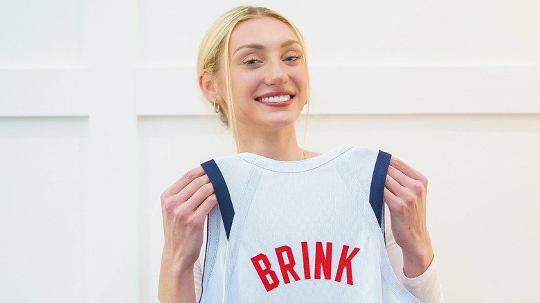 Cameron Brink holding up jersey