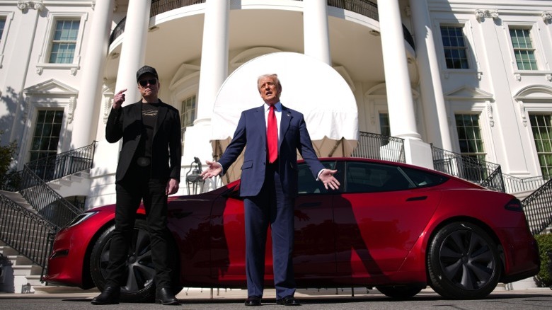 Elon Musk and Donald Trump in front of a Tesla at the White House