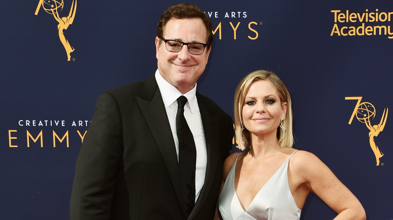 Candace Cameron Bure and Bob Saget pose 