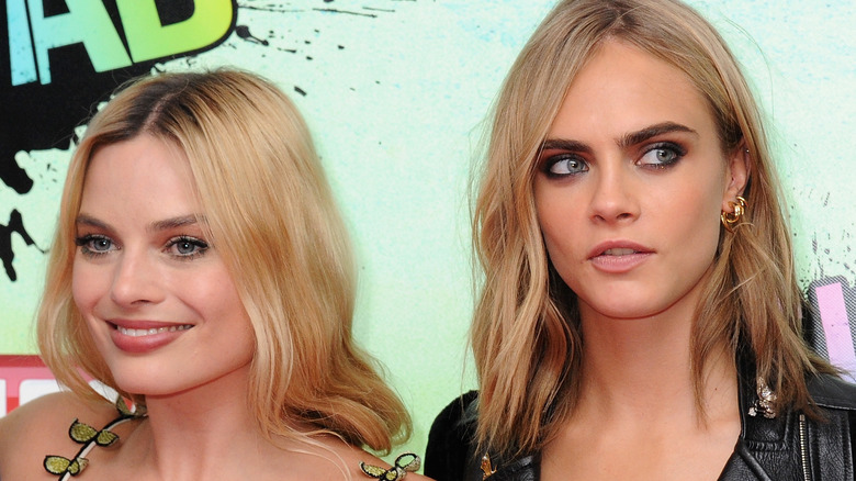 Margot Robbie and Cara Delevingne posing at an event