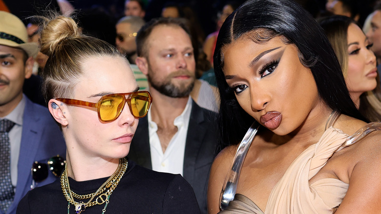 Cara Delevingne staring at Megan Thee Stallion