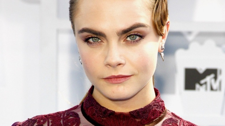 A closeup of Cara Delevingne, eyebrow raised