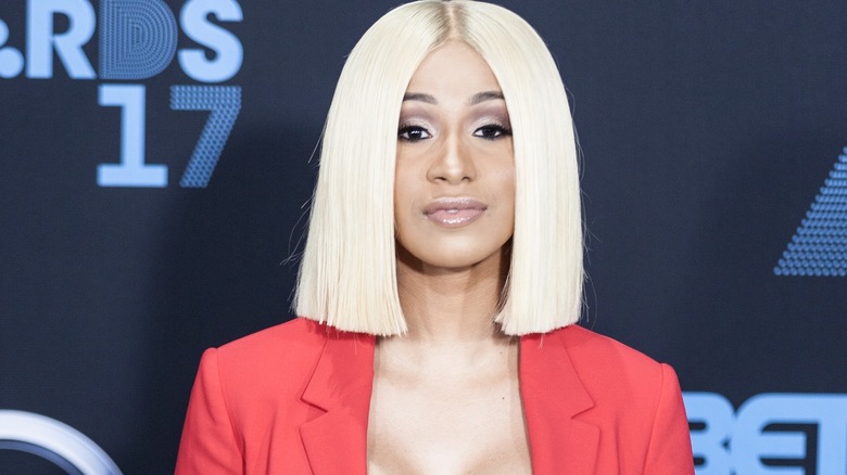 Cardi B, smirking