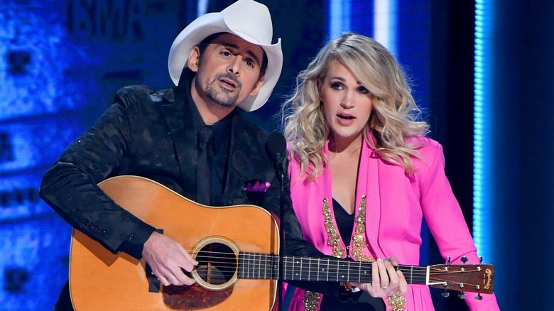 Hosts Brad Paisley and Carrie Underwood speak onstage during the 52nd annual CMA Awards