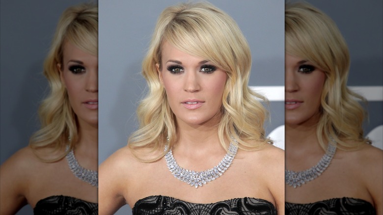 Carrie Underwood posing, wearing a $31 million diamond necklace.