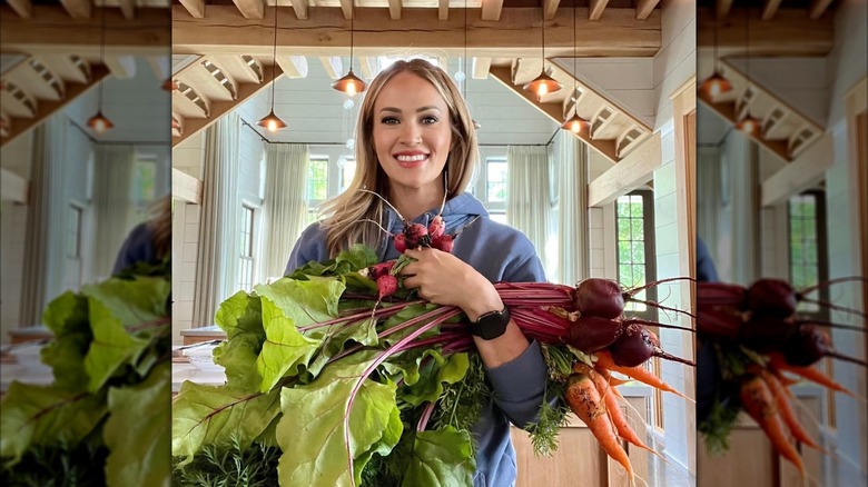 Carrie Underwood shows off veggies from her garden in her kitchen.