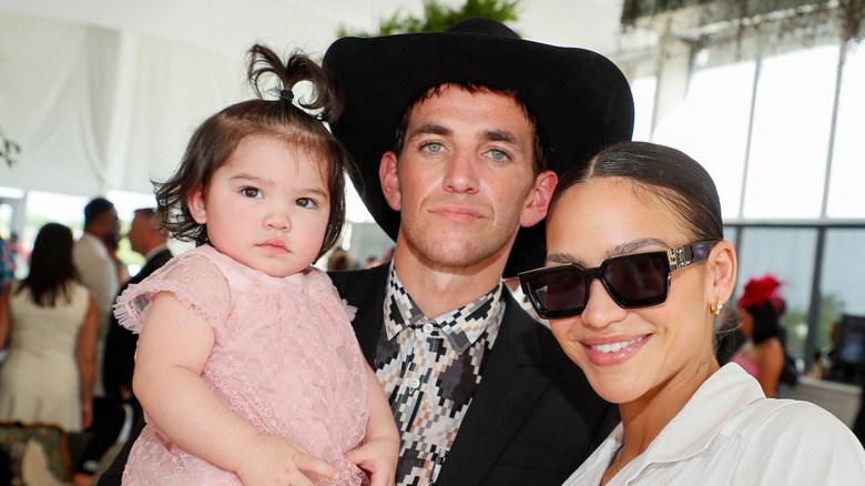 Cassie and Alex Fine pose with baby daughter