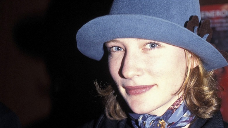 A young Cate Blanchett in a blue hat