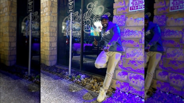 Ceaser Emanuel smiling outside of Black Ink Houston 