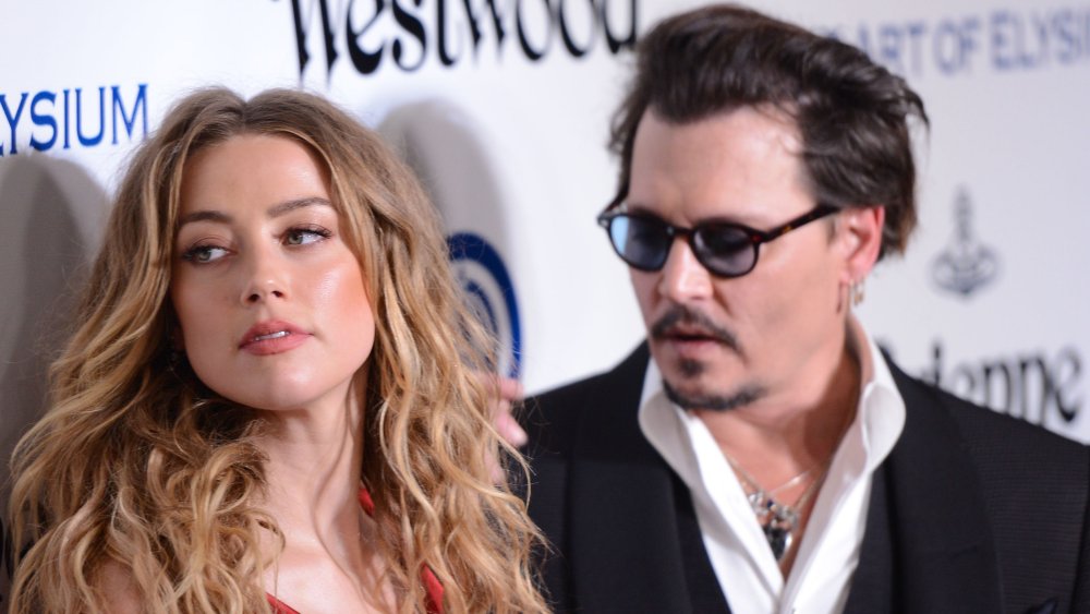 Amber Heard and Johnny Depp both gazing off camera