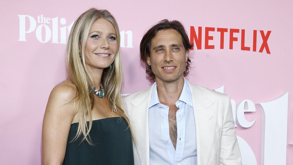 Gwyneth Paltrow and Brad Falchuk in front of a pink wall