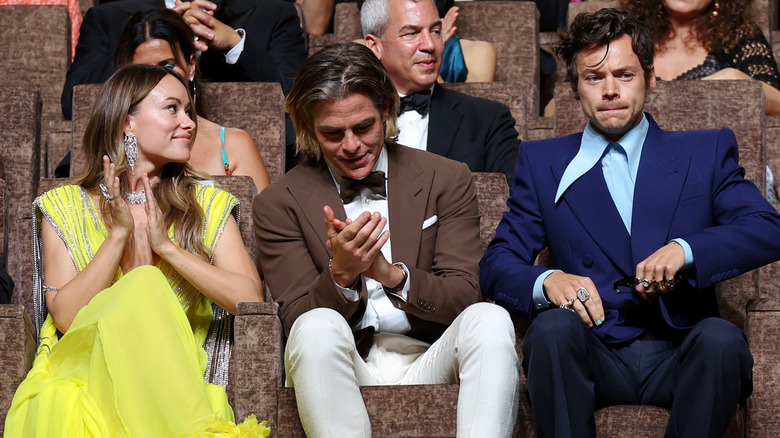 Olivia Wilde, Chris Pine, and Harry Styles seated