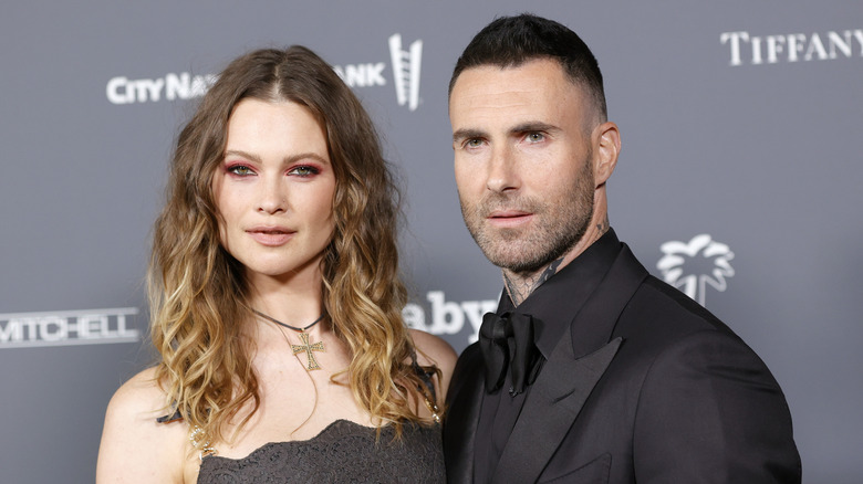 Behati Prinsloo and Adam Levine posing together