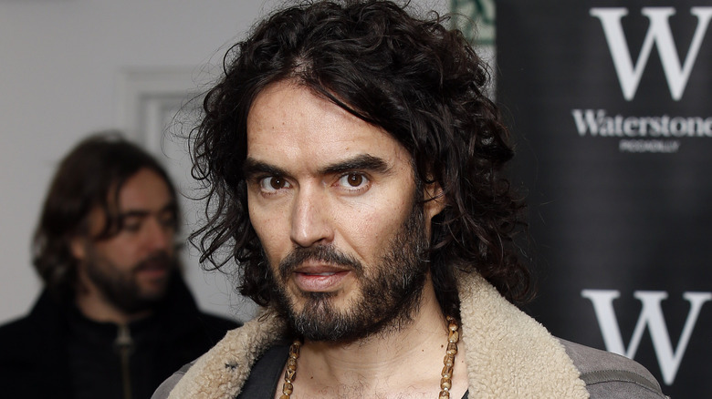 Russell Brand posing