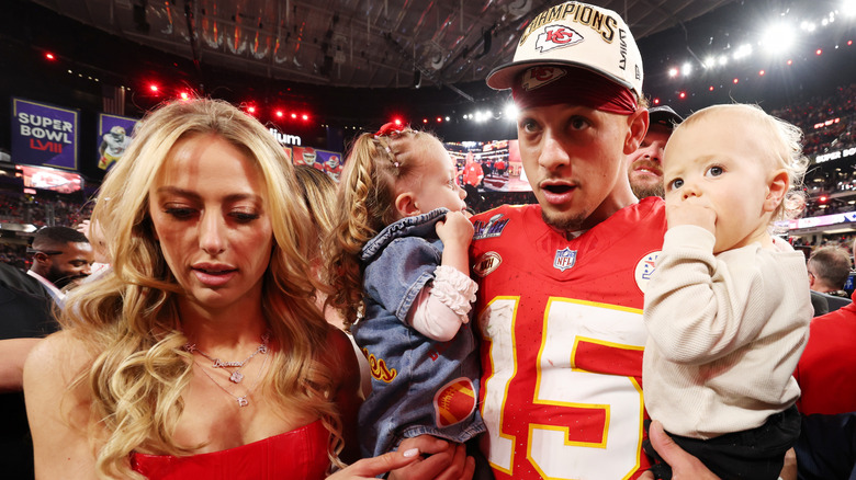 Patrick and Brittany Mahomes holding two kids as babies