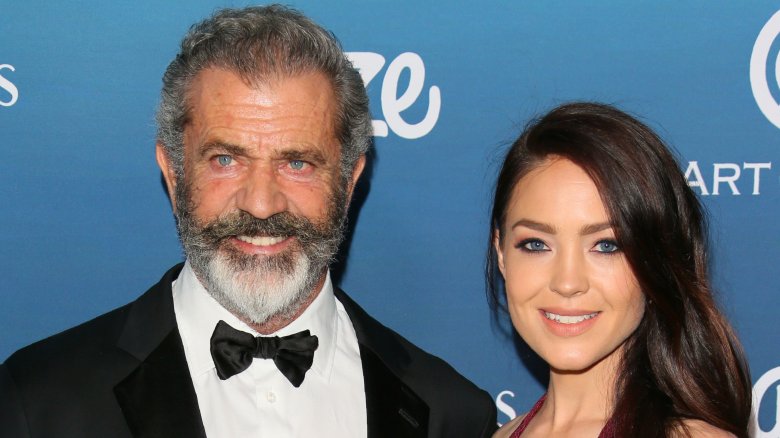 Mel Gibson and Rosalind Ross smiling on the red carpet