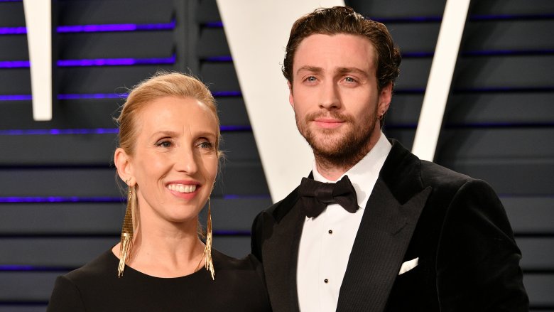 Sam Taylor-Johnson, Aaron Taylor-Johnson smiling on red carpet