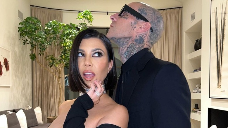 Travis Barker with chin on Kourtney Kardashian's head