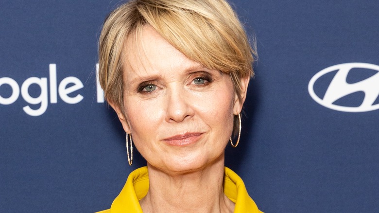 Cynthia Nixon smiling with hoops