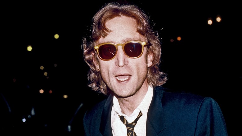 John Lennon wearing a suit on the street