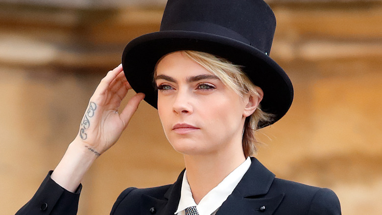 Cara Delevingne wearing a hat, posing