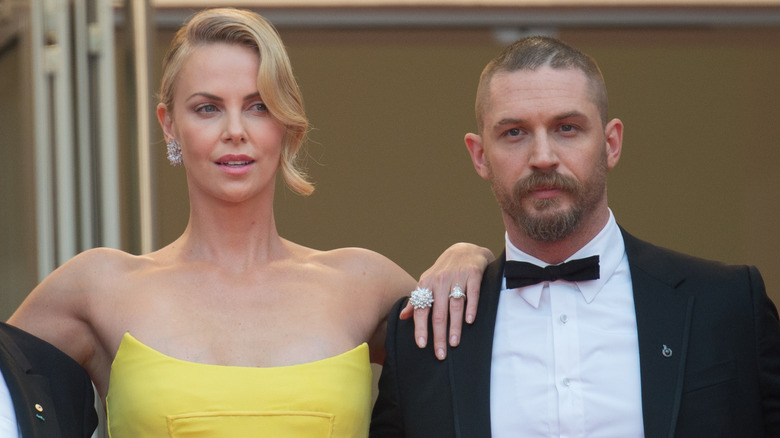 Tom Hardy and Charlize Theron posing