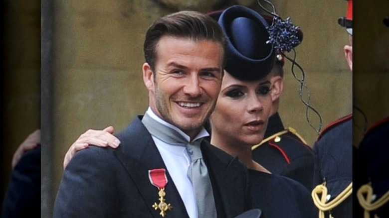 David Beckham smiling with Victoria Beckham